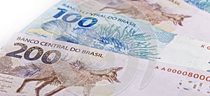 Banknotes of money from brazil in the values Ã¢â¬â¹Ã¢â¬â¹of 100 and 200 reais, wolf guar photo